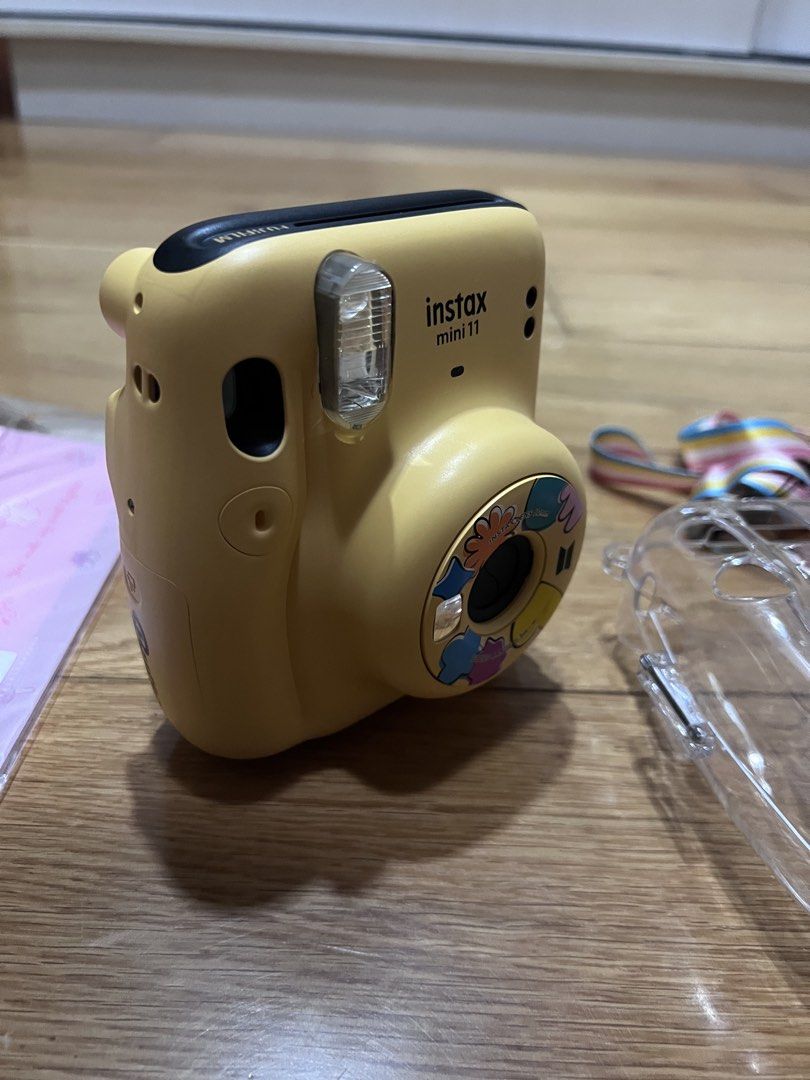 Fujifilm Instax Mini 11 BTS BUTTER VERSION with Accessories (Category: Cameras) located in Pasay City. Submitted by janellerae (Listing ID 1443824297, Image 2). Description: - SELLING AS IT IS: BTS BUTTER VERSION Fujifilm Instax Mini 11 camera - Comes with a clear protective case - Features a colorful strap - Bonus: Pink My Melody film pack - Ideal for instant memory capturing - Ready for your next adventure!.