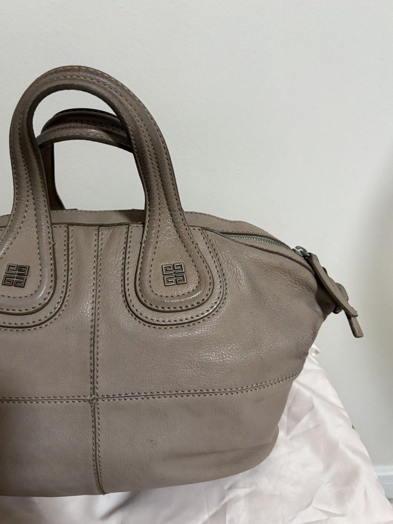 Givenchy Nightingale Leather Handbag (Category: Luxury Bags & Wallets) located in Del Monte. Submitted by gentlehawk-37b0 (Listing ID 1443755593, Image 2). Description: - Authentic Taupe Givenchy Nightingale Bag - Made of genuine leather - Iconic design with top handles - Includes a detachable shoulder strap for versatile carrying - Shows some signs of wear on the handles and leather - Perfect for everyday use.
