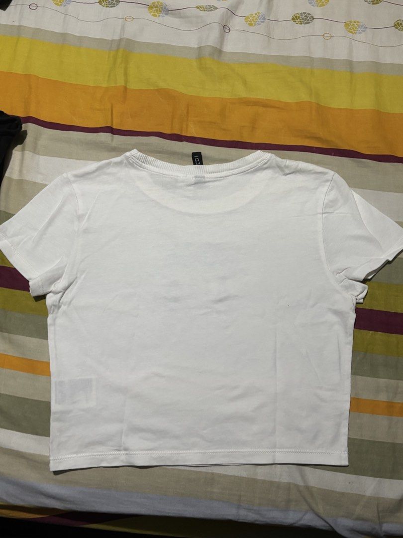 H&M Divided White Cropped T-shirt with Blue Crest Graphic (Category: Shirts) located in Bauan. Submitted by danadtngn (Listing ID 1443825708, Image 3). Description: Last used back in 2019. A bit yellowish from being kept in the closet for too long but still pretty, just needs some laundry. .