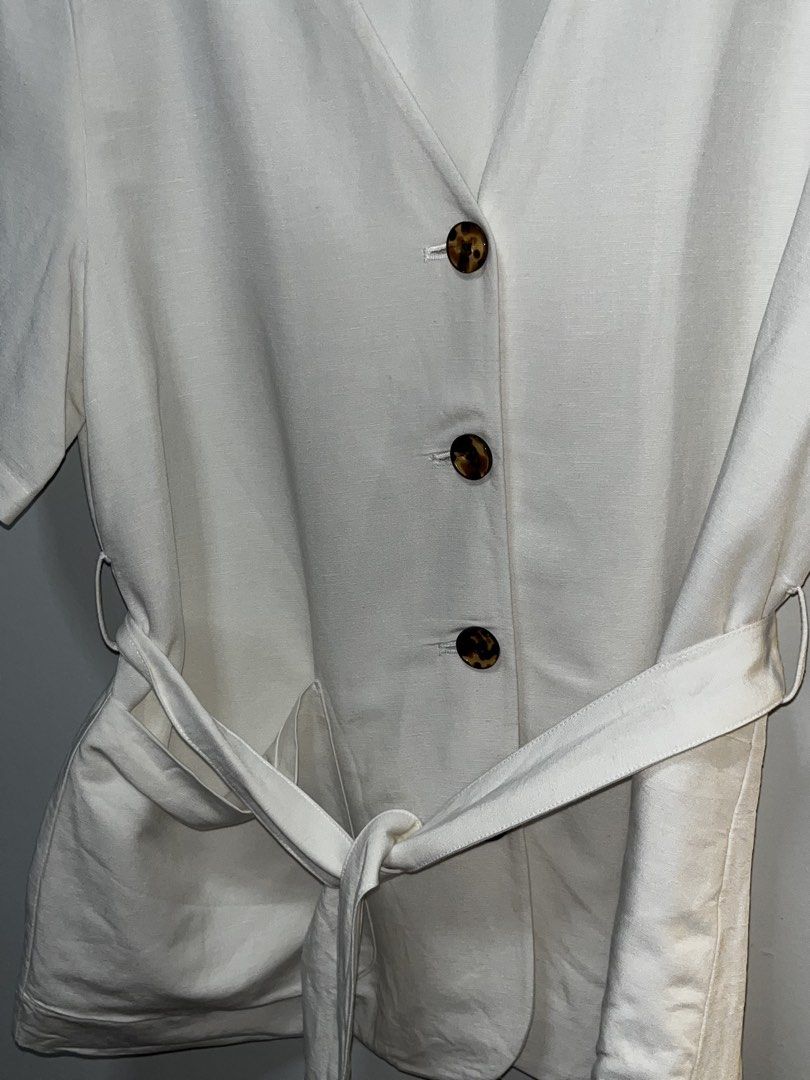 H&M Linen Blend White Button-Up Belted Top Size L (Category: Blouses) located in Marikina City. Submitted by beautygirlph (Listing ID 1443876423, Image 2). Description: USED ONCE - Brand: H&M - Material: Linen blend - Color: White - Neckline: V-neck - Closure: Button-up front with tortoise shell buttons - Features: Matching fabric belt, short sleeves, two front pockets - Style: Versatile for casual or dressed-up looks.