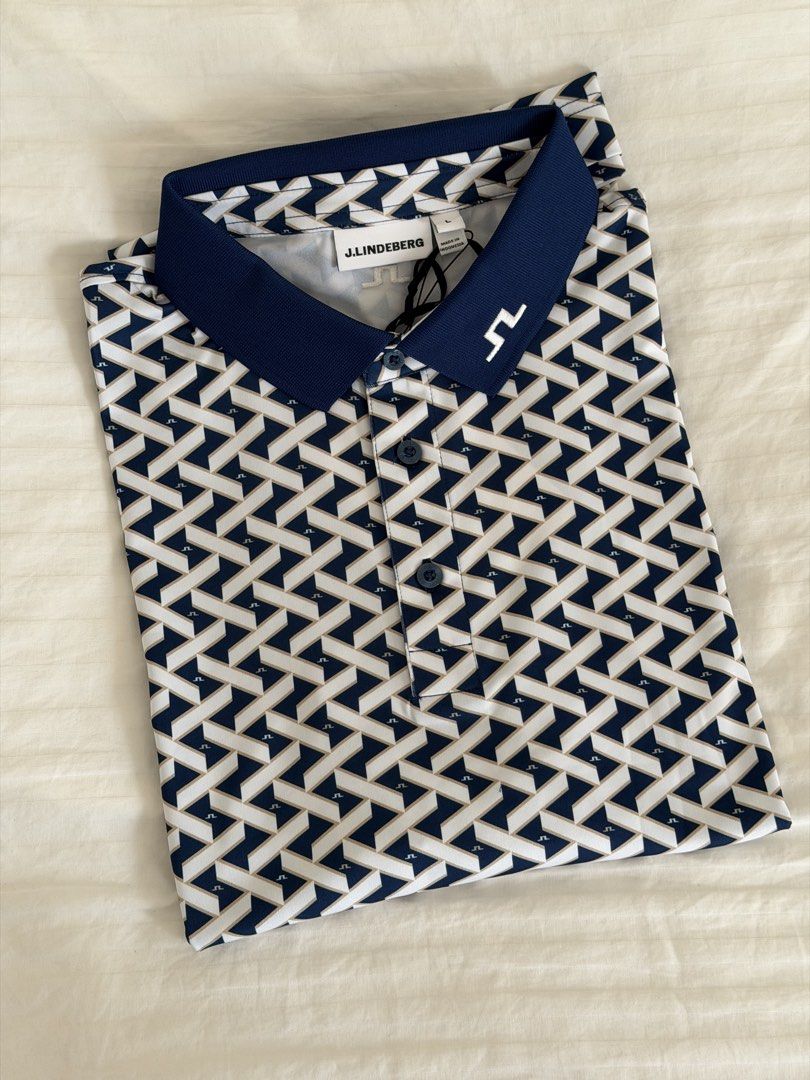 j.lindeberg Tour Tech Print Polo in LARGE (Category: Tshirts & Polo Shirts ) located in Makati City. Submitted by dlhp__ (Listing ID 1443839975, Image 2). Description: - Brand: J. Lindeberg - Type: Golf Polo - Size: L - Color/Pattern: Navy and white geometric pattern - Sleeve Style: Short sleeves with navy trim - Closure: Button-up front with navy buttons - Occasion: Ideal for golf or casual wear.