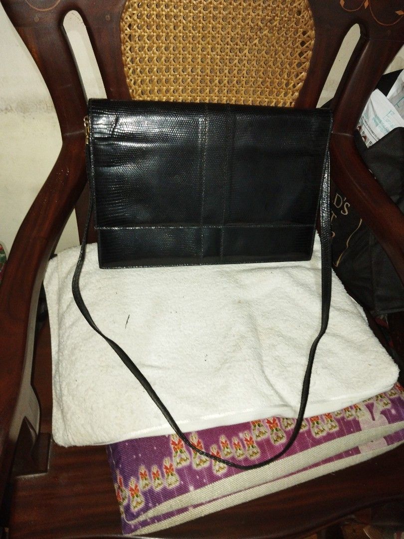 Launer bag (Category: Luxury Bags & Wallets) located in Makati City. Submitted by fiercewind.7bf54e (Listing ID 1443774368, Image 2). Description: - Authentic Launer bag - Classic black color - Sophisticated lizard-embossed texture - Elegant gold hardware - Versatile design for any occasion.