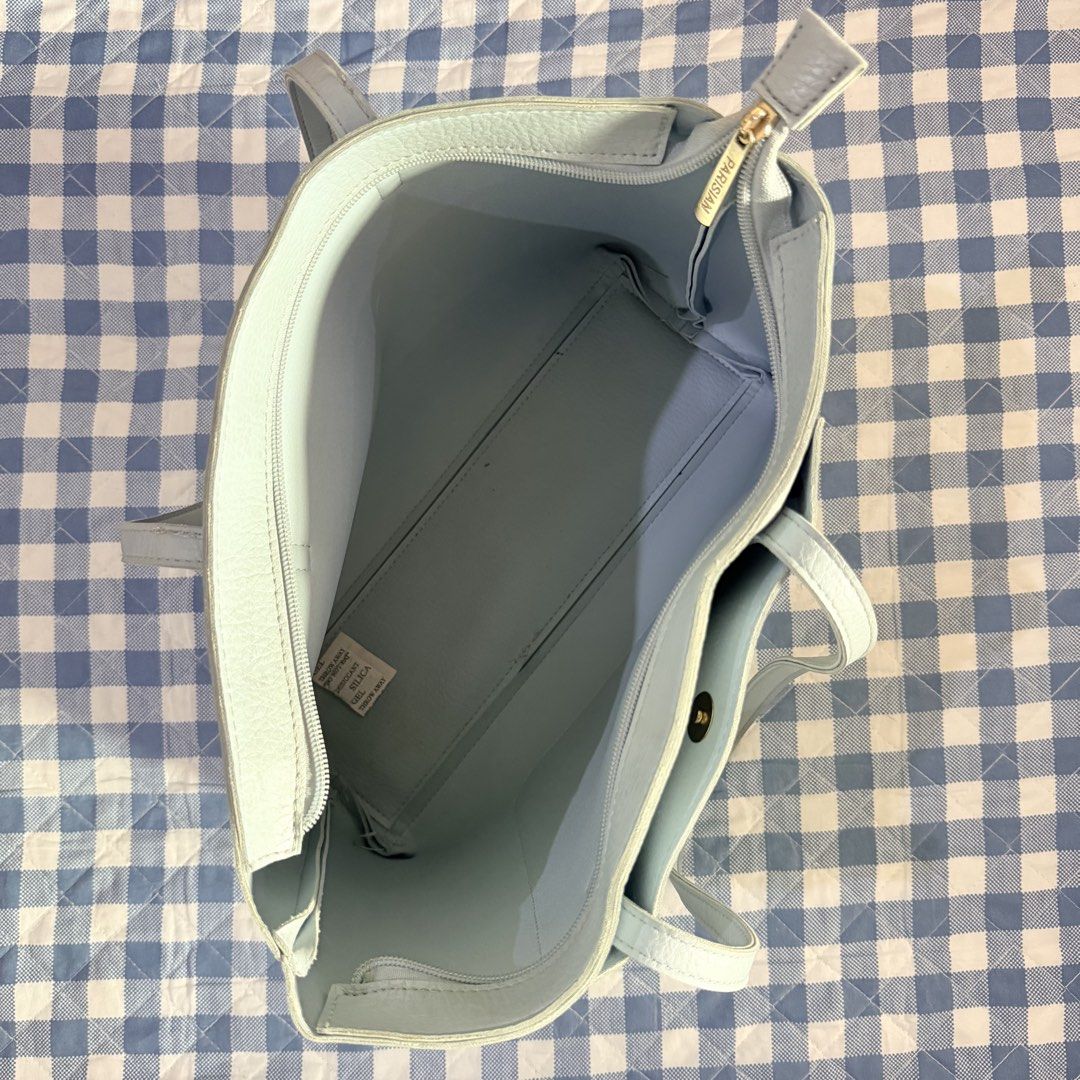 Light Blue Parisian Tote Bag with Front Pocket (Category: Tote Bags) located in Manila. Submitted by swiftgem_e3844a (Listing ID 1443763804, Image 3). Description: - Light blue tote bag - Front pocket with snap closure - Zip-top main compartment - Interior zippered pocket - Internal divider - 'PARISIAN' engraved zipper pull - Ideal size for everyday use.