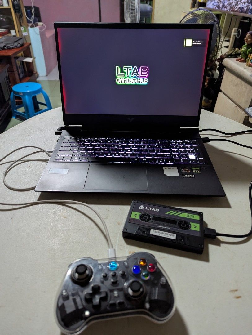 LTAB Gaming Hub Retro Console with Controller and Case (Category: Controllers) located in Quezon City. Submitted by cojikmendez (Listing ID 1443711468, Image 1). Description: FOR SALE DI NA NAGAGAMIT! LTAB RETRO DRIVE USED LANG PO FOR A WEEK THEN DI NA NAGAMIT. ISSUE: DI MACONNECT SA WIRELESS YUNG CONTROLLER, WALA PONG CORD YUNG CONTROLLER TYPE C NAMAN SIYA PWEDE GAMITIN MGA PANG CHARGER. 📍PLEASANT / SAVANO / SM SJDM 💵Gcash / Maya / Bank Transf