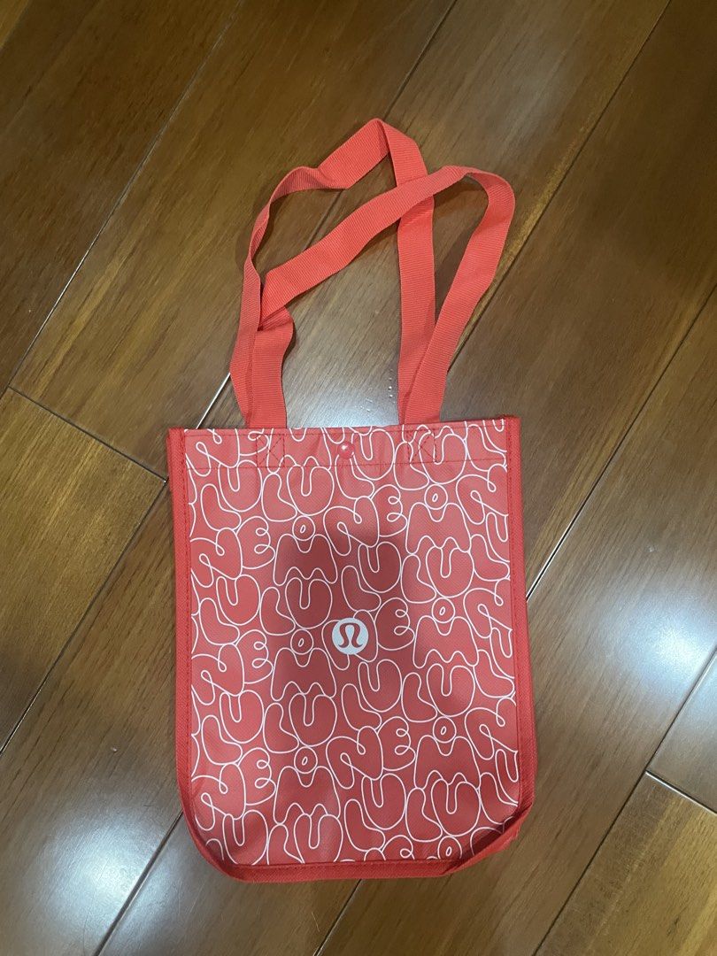 Lululemon Shopping / Paper Tote Bag (Category: Tote Bags) located in Mandaluyong City. Submitted by beautyfashdeclutter (Listing ID 1443834896, Image 1). Description: - Cute Lululemon tote bag - Color: Red with all-over white abstract pattern - Features two red handles - Ideal for carrying daily essentials - Perfect size for everyday use.