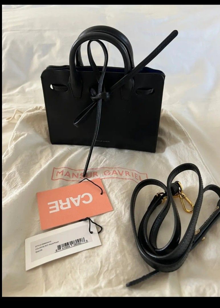 Mansur Gavriel Mini Bucket Bag Black Leather Blue Interior (Category: Luxury Bags & Wallets) located in San Juan City. Submitted by simplyj18 (Listing ID 1443769760, Image 1). Description: - Authentic Mansur Gavriel Mini Bucket Bag - Color: Black leather exterior, vibrant blue interior - Features: Top handles, detachable crossbody strap - Includes: Original dust bag and tags - Condition: wear or peeling on interior edges (as pictured).