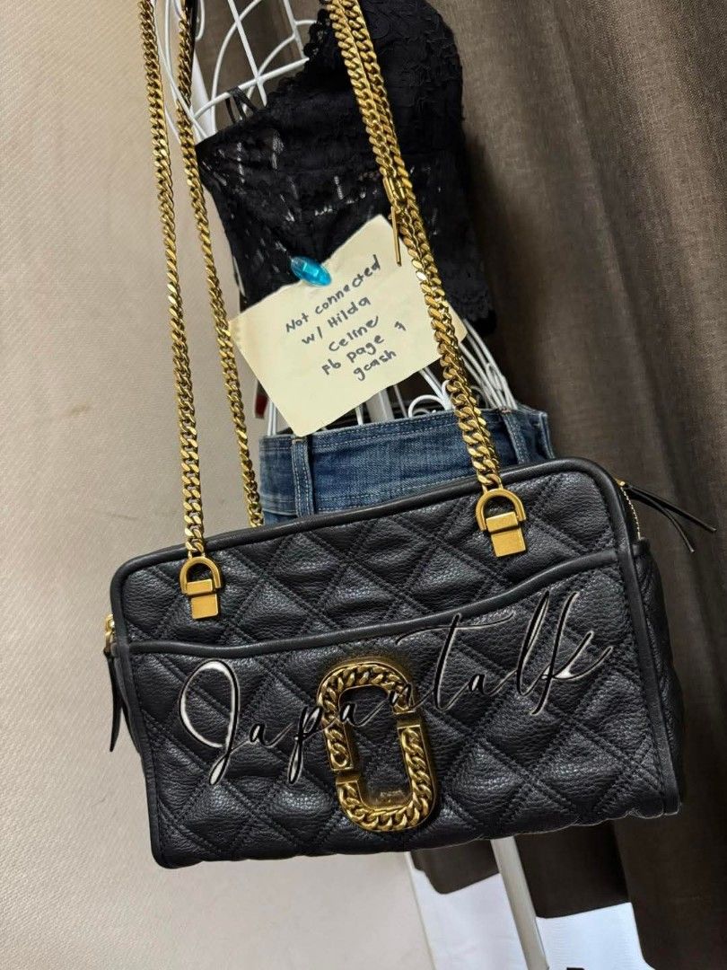 Marc Jacobs Black Quilted Leather Camera Bag Gold Chain (Category: Luxury Bags & Wallets) located in Bulacan. Submitted by vintage_purge (Listing ID 1443758278, Image 2). Description: - Authentic Marc Jacobs black quilted leather camera bag - Features iconic gold MJ logo hardware - Chunky gold chain strap for a stylish look - Convenient front pocket for quick access - Secure zip closure to keep your belongings safe - Versatile for everyday use or