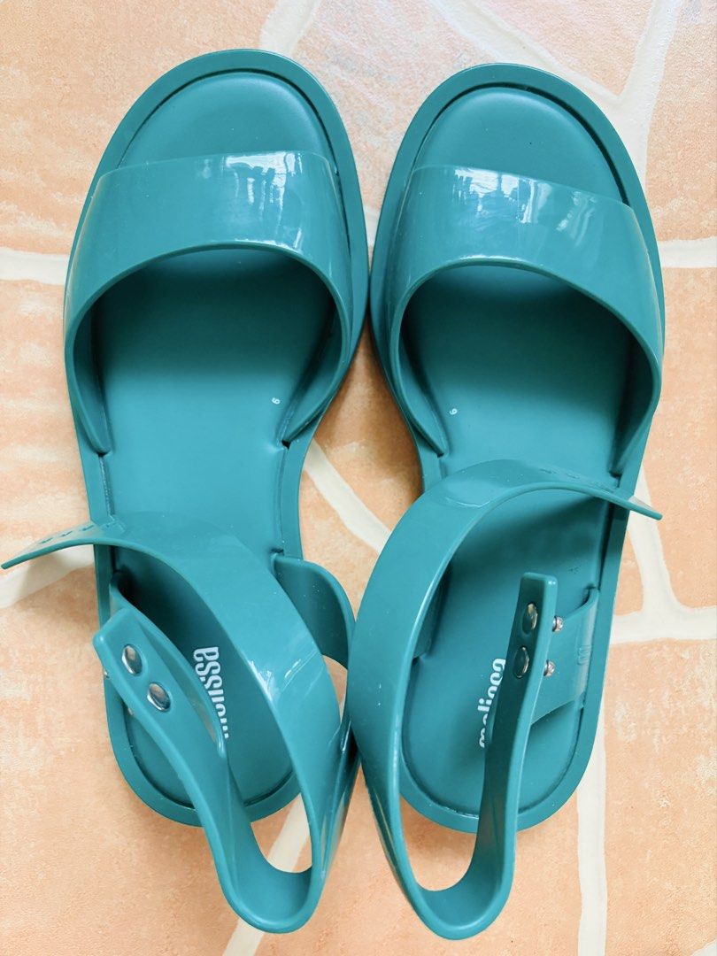Melissa Teal Jelly Ankle Strap Sandals (Category: Flats & Sandals) located in Tanjay. Submitted by cardiboo143 (Listing ID 1443704685, Image 2). Description: - Melissa green jelly sandals ORIGINAL - Ankle strap with buckle closure - Open toe design - Made from durable PVC - Ideal for casual outings and beach days - Features a grippy tread on the sole Used only twice (realized it isn’t my style) Very durable and comfy to wear.
