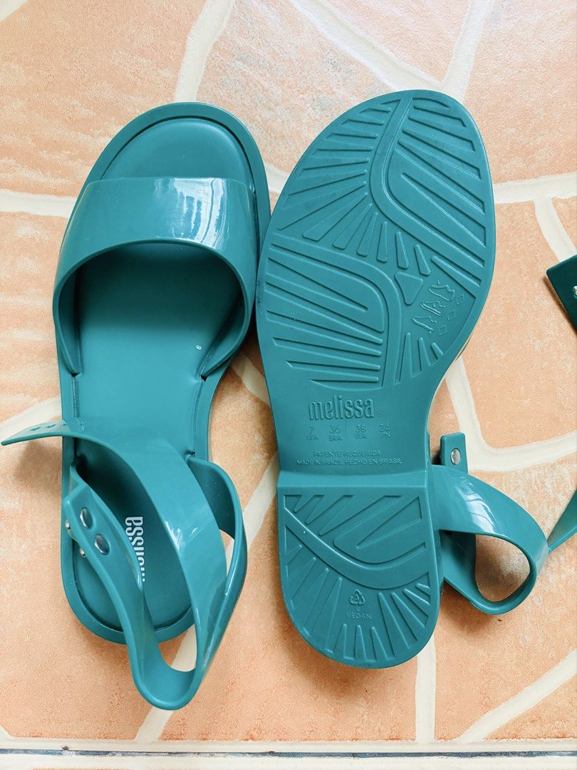 Melissa Teal Jelly Ankle Strap Sandals (Category: Flats & Sandals) located in Tanjay. Submitted by cardiboo143 (Listing ID 1443704685, Image 3). Description: - Melissa green jelly sandals ORIGINAL - Ankle strap with buckle closure - Open toe design - Made from durable PVC - Ideal for casual outings and beach days - Features a grippy tread on the sole Used only twice (realized it isn’t my style) Very durable and comfy to wear.