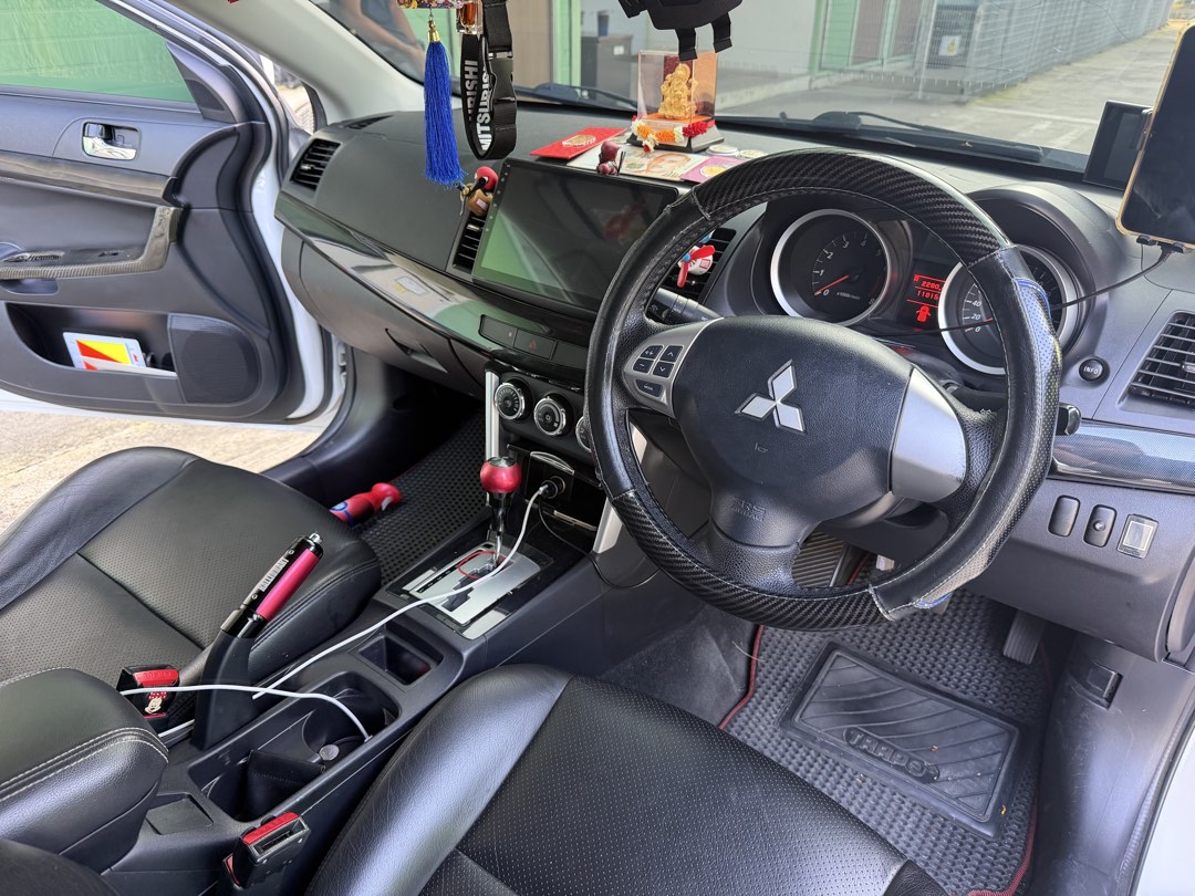 Mitsubishi Lancer EX 1.6 Classic (A) (Category: Used Cars) located in Singapore. Submitted by swiftautosupply (Listing ID 1443707264, Image 3). Description: White Mitsubishi Lancer EX 1.6A. Clean interior with aftermarket head unit.D1 Spec brake kit with coilover suspension and vented front hood.Well maintained. Carbon fibre interior.Wear and tear replaced with receipts.Ready for new owner. Viewing by appointment.Not in rush to sell,No dealers or