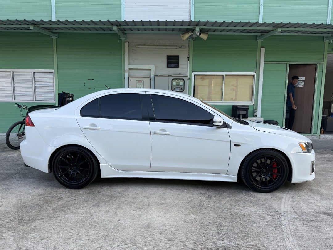 Mitsubishi Lancer EX 1.6 Classic (A) (Category: Used Cars) located in Singapore. Submitted by swiftautosupply (Listing ID 1443707264, Image 2). Description: White Mitsubishi Lancer EX 1.6A. Clean interior with aftermarket head unit.D1 Spec brake kit with coilover suspension and vented front hood.Well maintained. Carbon fibre interior.Wear and tear replaced with receipts.Ready for new owner. Viewing by appointment.Not in rush to sell,No dealers or