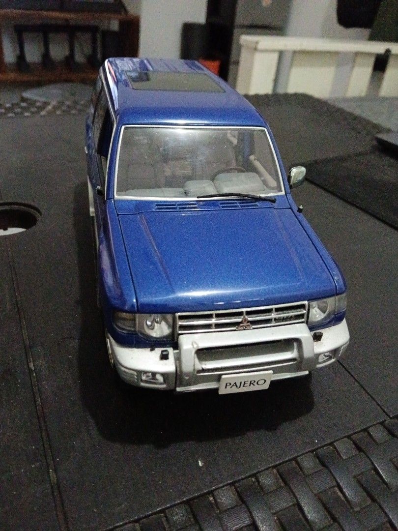 Mitsubishi Pajero AutoArt (Category: Vehicle & Diecast Models) located in San Pedro. Submitted by lorenz_218 (Listing ID 1443728632, Image 3). Description: AUTOart 1:18 Mitsubishi Pajero Diecast Model 💙 Blue/Silver Two-Tone ✅ Genuine AUTOart 1:18 Scale ✅ Opening doors, hood, and tailgate ✅ Detailed interior and undercarriage ✅ Rare collector's item Condition: Good overall display condition Missing 1 side mirror and 1 wiper Paint and body still p