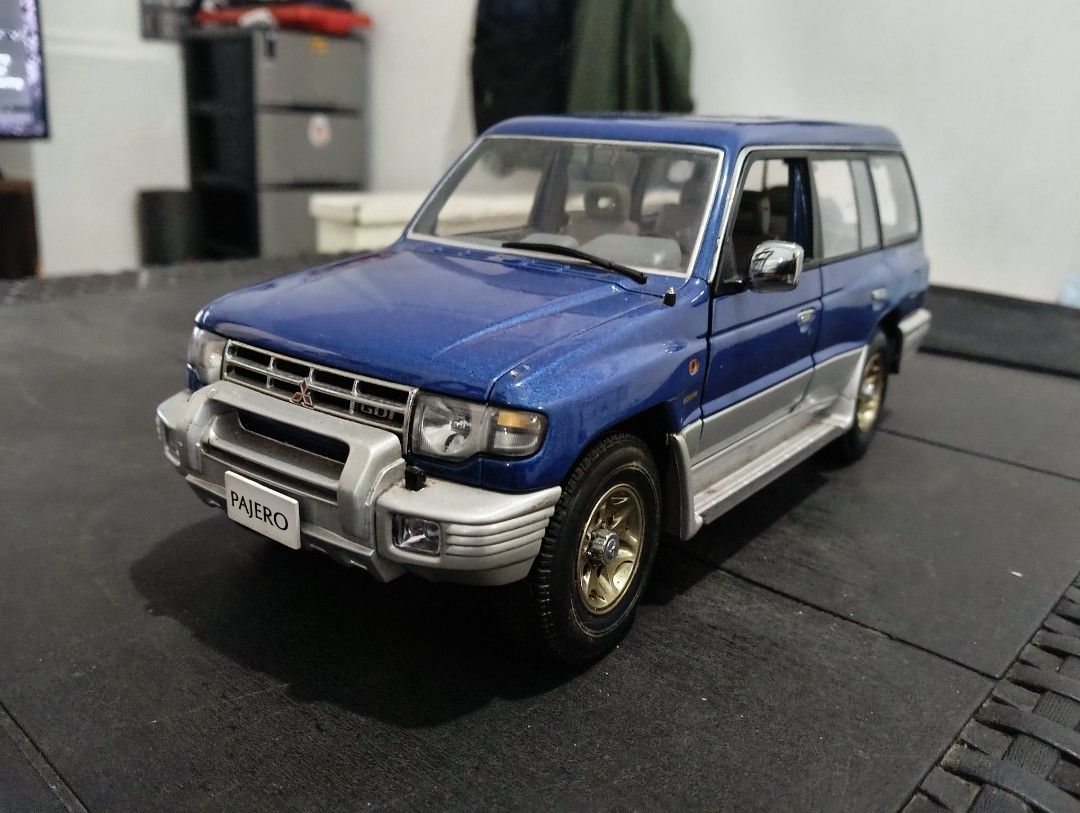 Mitsubishi Pajero AutoArt (Category: Vehicle & Diecast Models) located in San Pedro. Submitted by lorenz_218 (Listing ID 1443728632, Image 1). Description: AUTOart 1:18 Mitsubishi Pajero Diecast Model 💙 Blue/Silver Two-Tone ✅ Genuine AUTOart 1:18 Scale ✅ Opening doors, hood, and tailgate ✅ Detailed interior and undercarriage ✅ Rare collector's item Condition: Good overall display condition Missing 1 side mirror and 1 wiper Paint and body still p