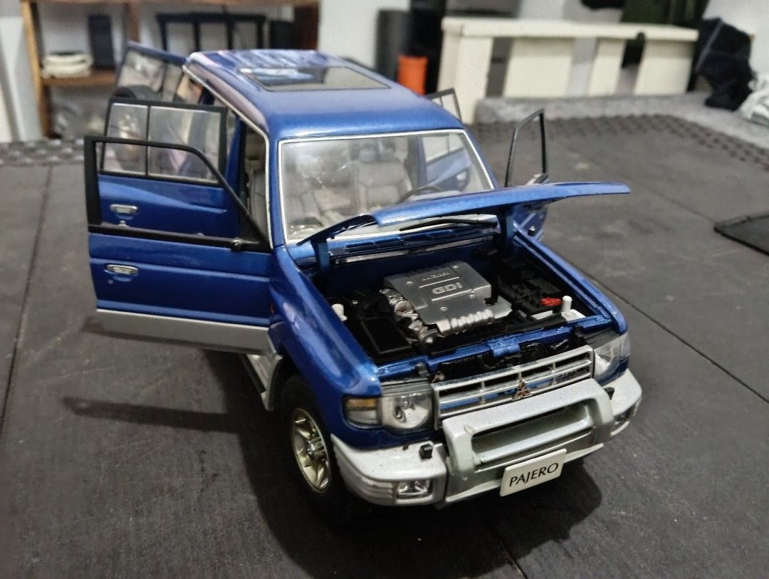 Mitsubishi Pajero AutoArt (Category: Vehicle & Diecast Models) located in San Pedro. Submitted by lorenz_218 (Listing ID 1443728632, Image 2). Description: AUTOart 1:18 Mitsubishi Pajero Diecast Model 💙 Blue/Silver Two-Tone ✅ Genuine AUTOart 1:18 Scale ✅ Opening doors, hood, and tailgate ✅ Detailed interior and undercarriage ✅ Rare collector's item Condition: Good overall display condition Missing 1 side mirror and 1 wiper Paint and body still p