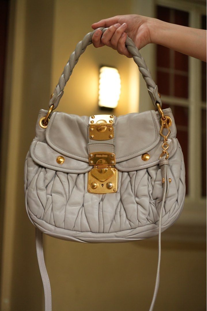 Miu Miu Light Gray Coffer Matelasse Bag (Small) (Category: Luxury Bags & Wallets) located in Quezon City. Submitted by dlm03 (Listing ID 1440710995, Image 2). Description: Authentic Miu Miu Coffer Bag crafted in luxurious leather with the iconic Matelassé detailing and gold-tone hardware. A timeless Y2K-era piece and one of Miu Miu’s most recognizable archive bags. Condition: • Excellent Preloved Condition (Rank A-/AB) • Soft and supple leather •