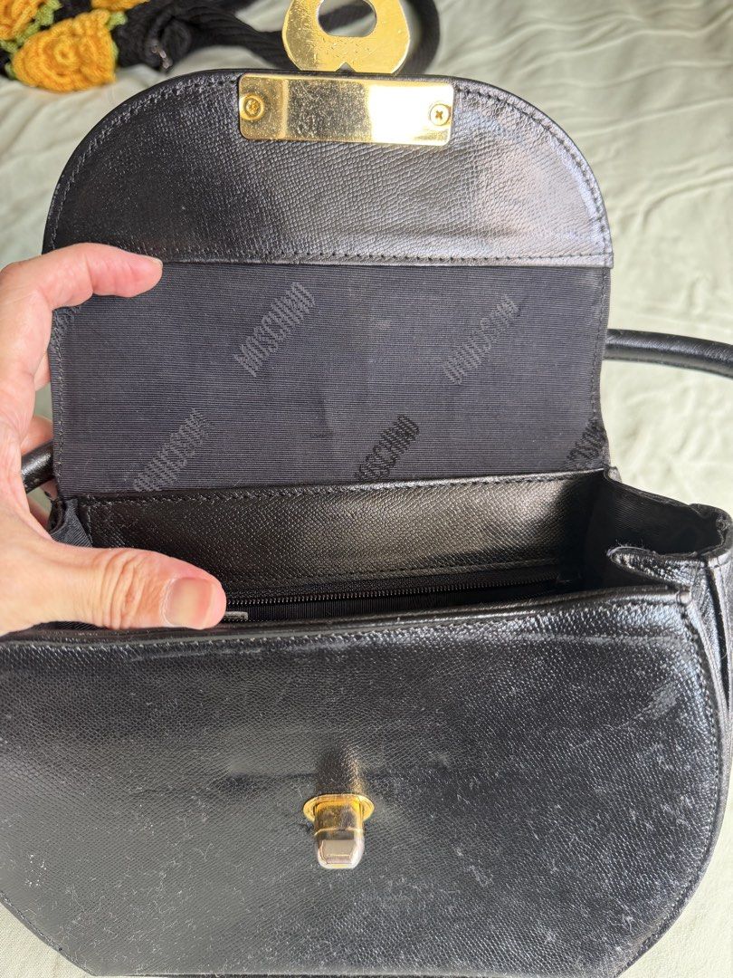 Moschino Black Heart Lock Shoulder Bag (Category: Luxury Bags & Wallets) located in Quezon City. Submitted by __lilyandpoppy (Listing ID 1443767603, Image 3). Description: - Vintage Moschino shoulder bag - Color: Black - Iconic gold heart lock closure - Moschino branding inside - Signs of wear on exterior and hardware (consistent with age) - Ideal for Moschino collectors - Classic piece.