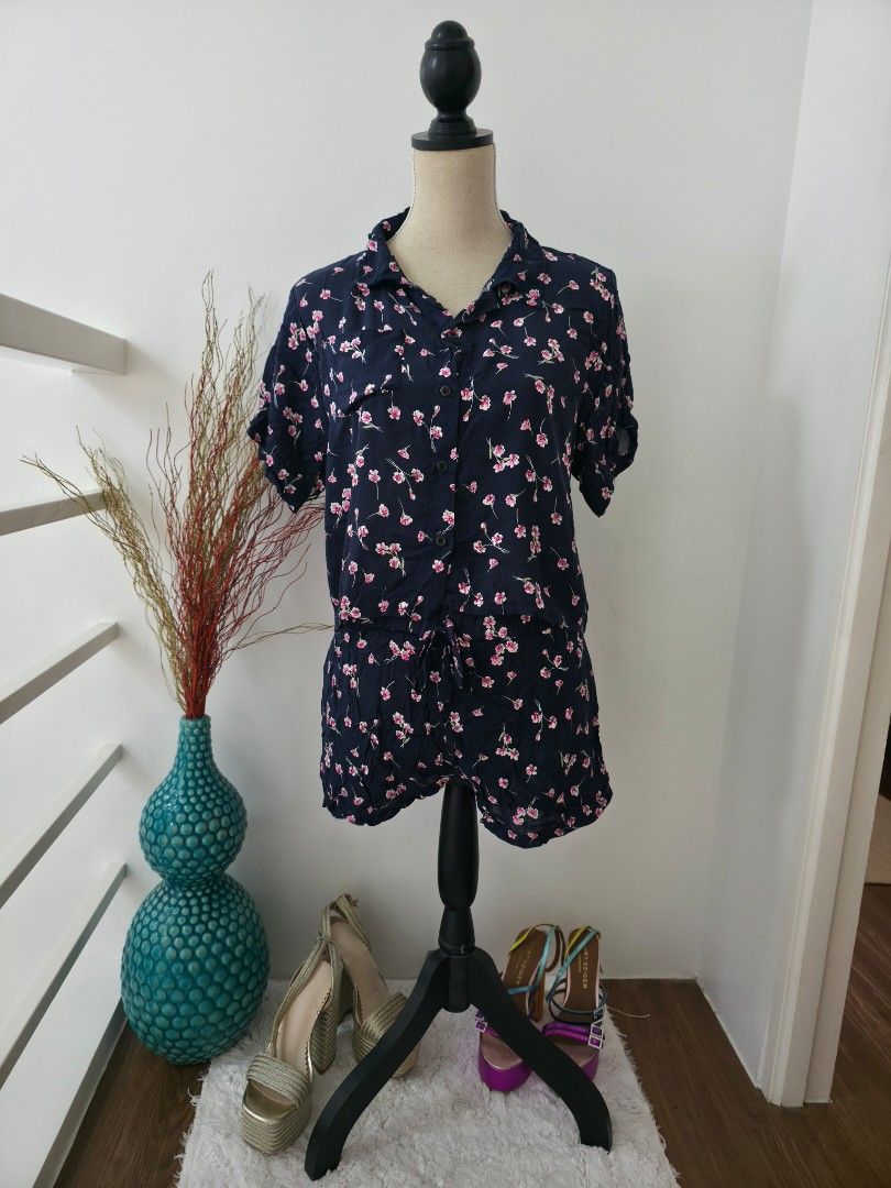 Navy Blue Floral Print Dress (Category: Dresses) located in Cavite. Submitted by aikoaiko (Listing ID 1443826041, Image 1). Description: - Navy blue dress with a vibrant floral print - Short sleeves and collared neckline - Button-up front - Ruffled hemline - Ideal for casual outings or beach days - Comfortable and stylish design.