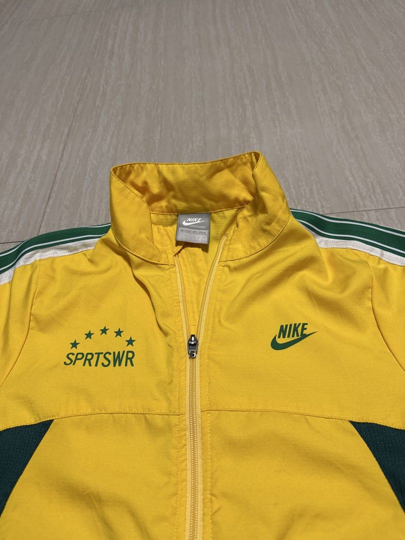 Nike SPRTSWR Track Jacket Yellow Green White (Category: Babies & Kids Fashion) located in Alfonso. Submitted by quickturtle_840b1e (Listing ID 1443821474, Image 2). Description: - Vibrant yellow Nike track jacket - Features green and white accent details - Iconic Nike logo on the chest - 'SPRTSWR' text with stars on the left chest - Full zip closure for easy wear - Perfect for athletic activities or everyday casual style PM me for queries 😊.