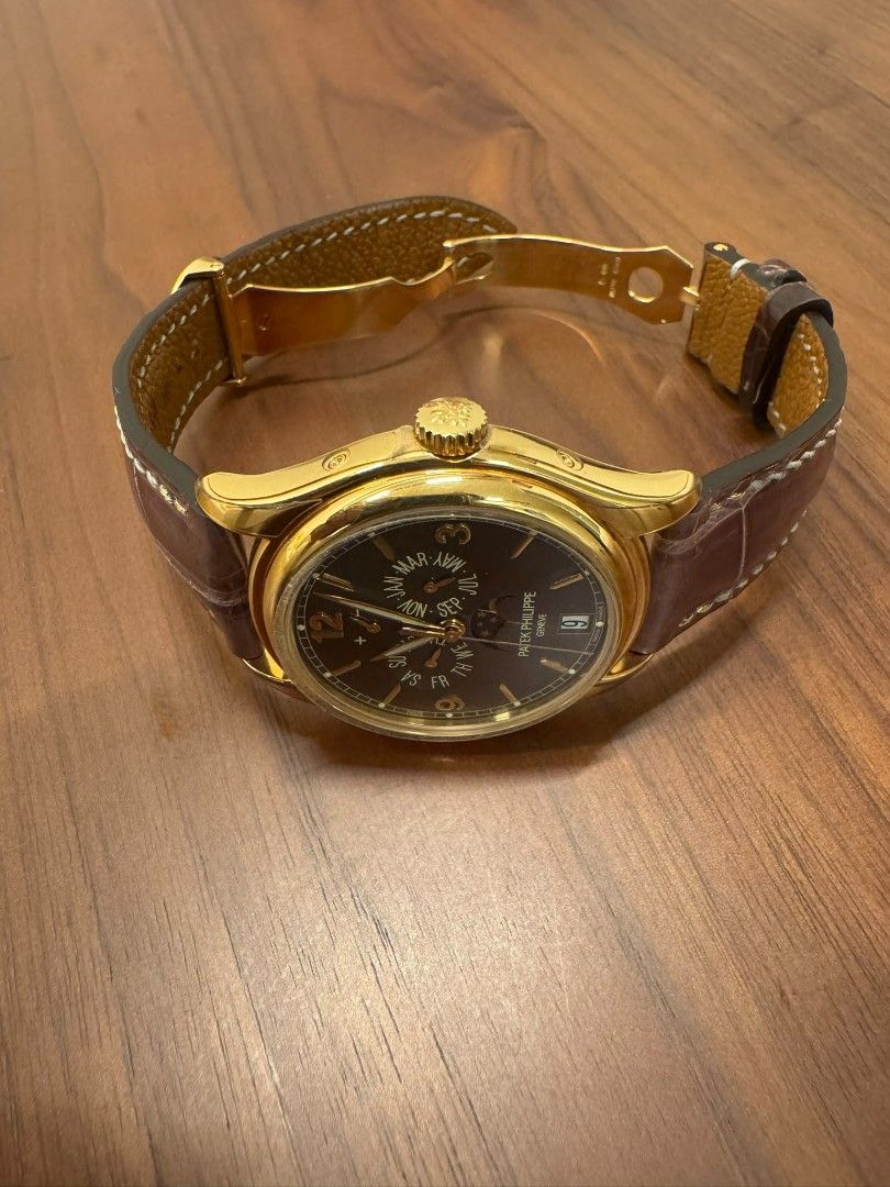 Patek Philippe 5146J-010 Yellow gold Annual Calendar (Category: Watches) located in Singapore. Submitted by bruisedbanner (Listing ID 1443813616, Image 3). Description: - Patek Philippe 5146J-010 - Yellow Gold Casing - Grey Dial - Annual Calendar - Day, Date, and Moon Phase Complications - Original Wooden Box - Certificate of Origin - Booklet - Leather Strap with Gold Buckle Full set dated 2015 Stickers applied Authentication costs to be borne by