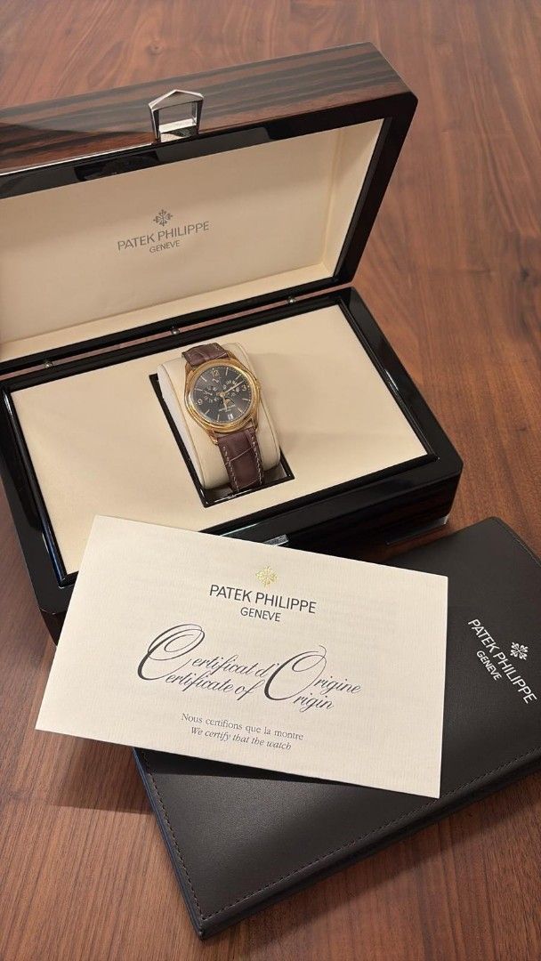 Patek Philippe 5146J-010 Yellow gold Annual Calendar (Category: Watches) located in Singapore. Submitted by bruisedbanner (Listing ID 1443813616, Image 2). Description: - Patek Philippe 5146J-010 - Yellow Gold Casing - Grey Dial - Annual Calendar - Day, Date, and Moon Phase Complications - Original Wooden Box - Certificate of Origin - Booklet - Leather Strap with Gold Buckle Full set dated 2015 Stickers applied Authentication costs to be borne by