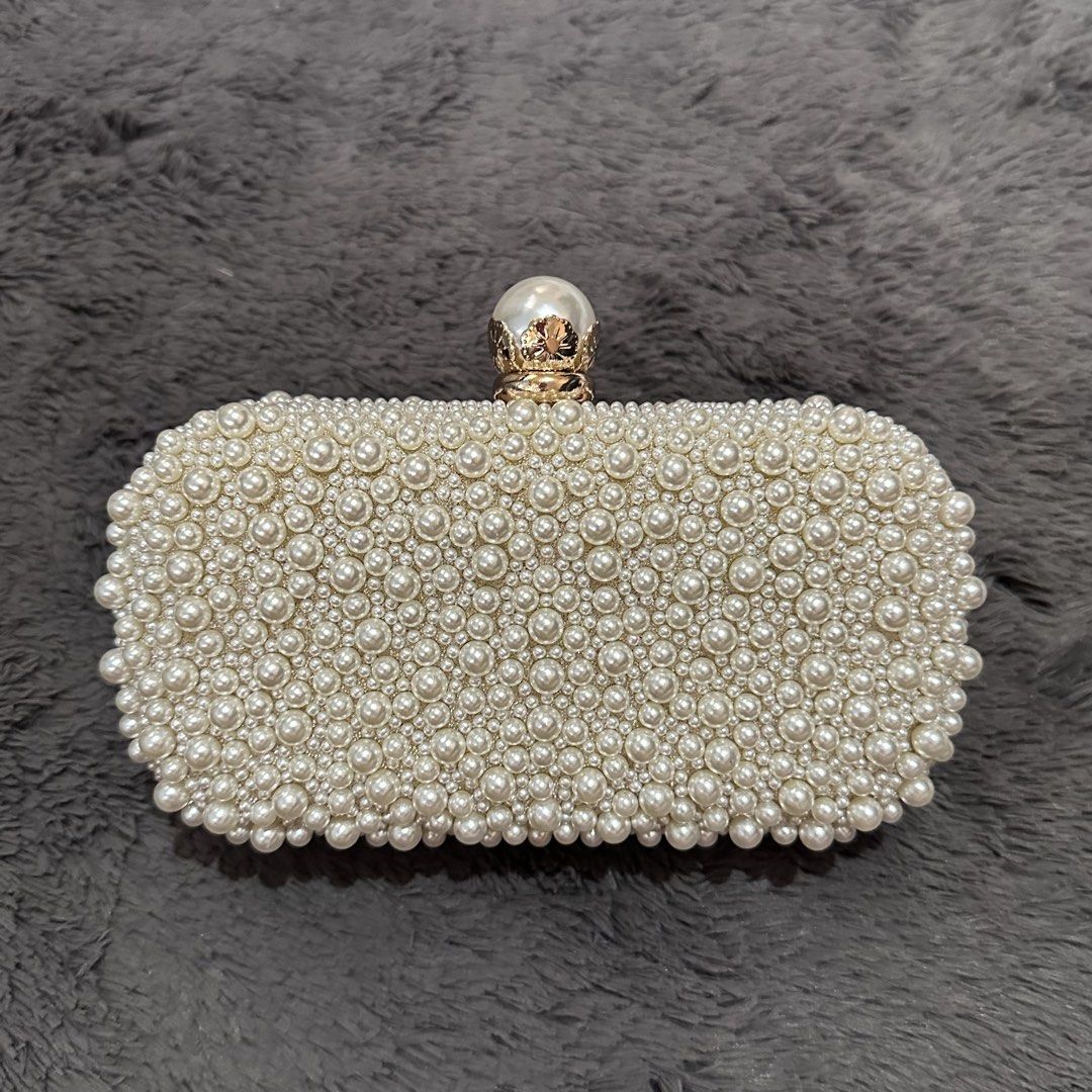 Pearl-like beaded off-white clutch bag (Category: Clutches) located in Marikina City. Submitted by sol.collective (Listing ID 1443870052, Image 1). Description: Fits up to iPhone Pro Max Versatile clutch bag for any occasion Best as wedding clutch bag On hand Same day delivery Discounted price posted already. Original price, ₱ 1800 .