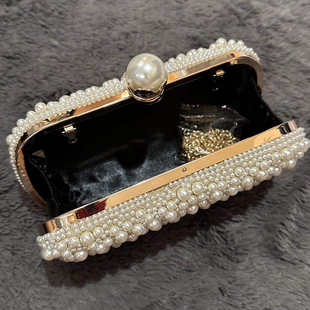 Pearl-like beaded off-white clutch bag (Category: Clutches) located in Marikina City. Submitted by sol.collective (Listing ID 1443870052, Image 3). Description: Fits up to iPhone Pro Max Versatile clutch bag for any occasion Best as wedding clutch bag On hand Same day delivery Discounted price posted already. Original price, ₱ 1800 .