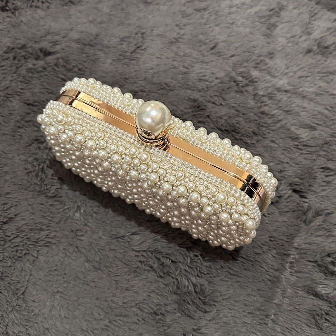 Pearl-like beaded off-white clutch bag (Category: Clutches) located in Marikina City. Submitted by sol.collective (Listing ID 1443870052, Image 2). Description: Fits up to iPhone Pro Max Versatile clutch bag for any occasion Best as wedding clutch bag On hand Same day delivery Discounted price posted already. Original price, ₱ 1800 .