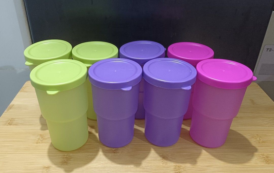 Plastic Cups with Lids (TAKE ALL) (Category: Water Bottles & Tumblers) located in Pasig City. Submitted by joaquin_1207 (Listing ID 1443861526, Image 1). Description: Set of 8 Tupperware tumblers (3 green, 3 purple, 2 pink). Includes lids. Stackable for space-saving. Perfect for drinks or storage, parties or daily use..