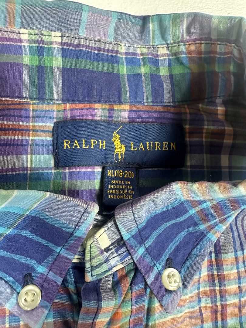 Polo Ralph Lauren Plaid Button Down Shirt (Category: Tshirts & Polo Shirts ) located in Manila. Submitted by collect__ph (Listing ID 1443705888, Image 3). Description: - Classic plaid button-down shirt - Brand: Polo Ralph Lauren - Color: Blue, purple, and green plaid pattern - Features: Button closure, embroidered pony logo on chest - Origin: Made in Indonesia - Size: 28” L x 20” W x 23” Sleeve length - Style: Perfect for casual or smart-casual o
