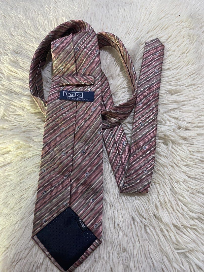 Polo Ralph Lauren Striped Silk Tie (Category: Ties) located in Bulacan. Submitted by rich2545 (Listing ID 1443715441, Image 2). Description: - Classic Polo Ralph Lauren tie - Elegant diagonal stripe pattern in pink, beige, and grey - Subtle woven paisley-like details - Made from luxurious silk - Ideal for formal events or business casual attire - A timeless and versatile accessory.