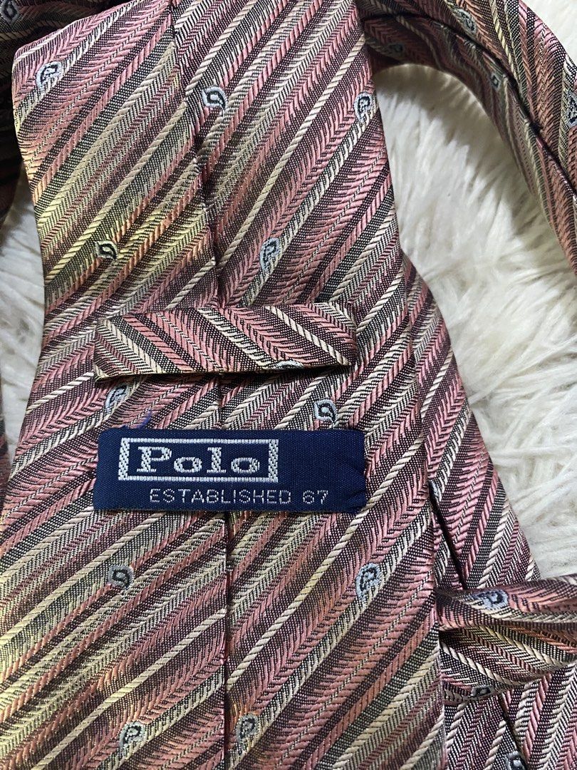 Polo Ralph Lauren Striped Silk Tie (Category: Ties) located in Bulacan. Submitted by rich2545 (Listing ID 1443715441, Image 3). Description: - Classic Polo Ralph Lauren tie - Elegant diagonal stripe pattern in pink, beige, and grey - Subtle woven paisley-like details - Made from luxurious silk - Ideal for formal events or business casual attire - A timeless and versatile accessory.