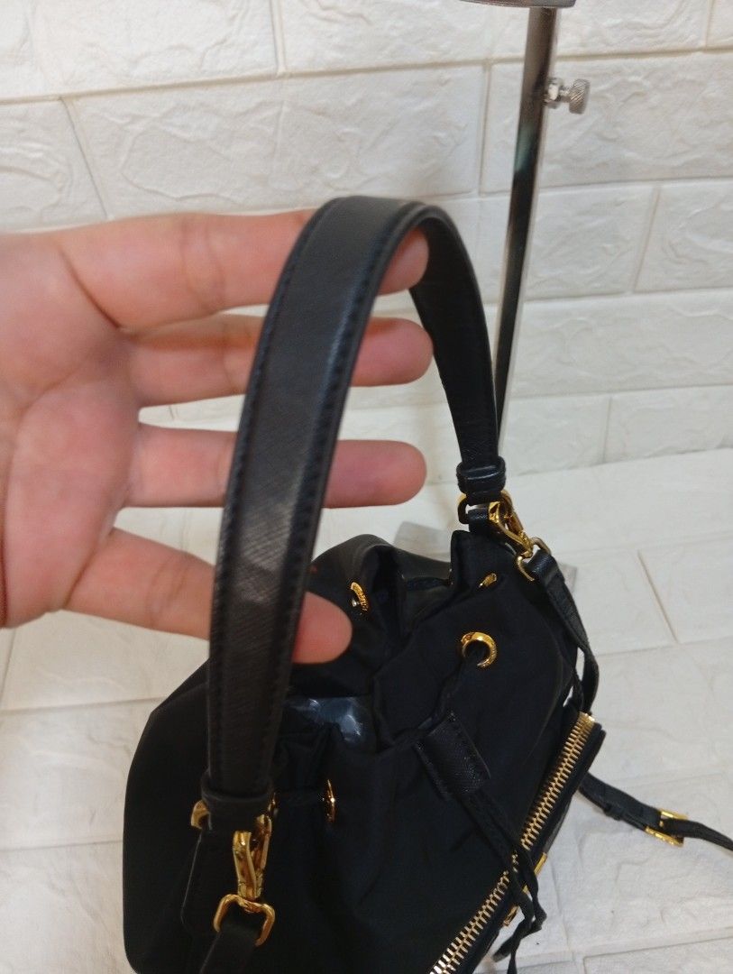 Prada Duet Re-Nylon Drawstring Bucket Bag (Category: Luxury Bags & Wallets) located in Las Pinas. Submitted by etoksi1234 (Listing ID 1443891537, Image 3). Description: Pre-loved Prada Duet Re-Nylon black bucket bag with gold hardware. Features adjustable strap, drawstring closure, and with RIRI front zip pocket. Made in Italy with white tag..