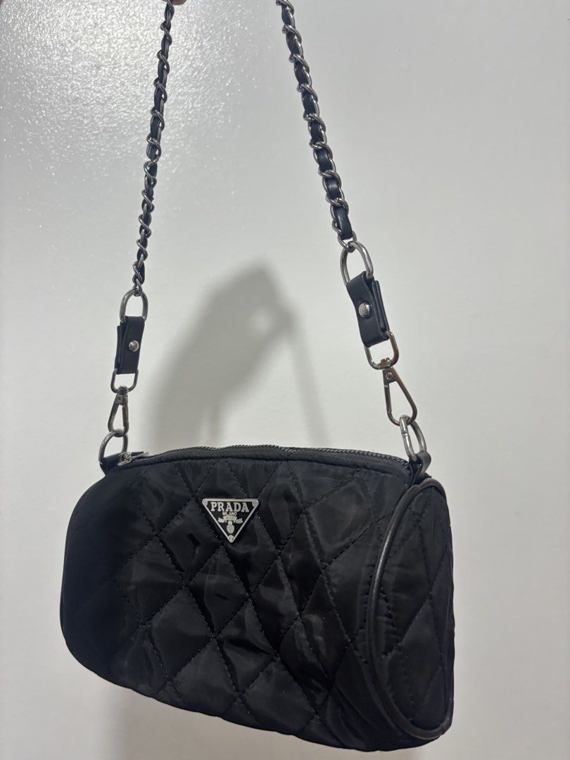 Prada Nylon Barrel Bag with Chain Strap (Category: Luxury Bags & Wallets) located in Taguig. Submitted by ikigai_vintageph (Listing ID 1443808038, Image 1). Description: - NGA Prada Chain Bag - Black quilted nylon barrel bag - Signature silver Prada logo on the front .