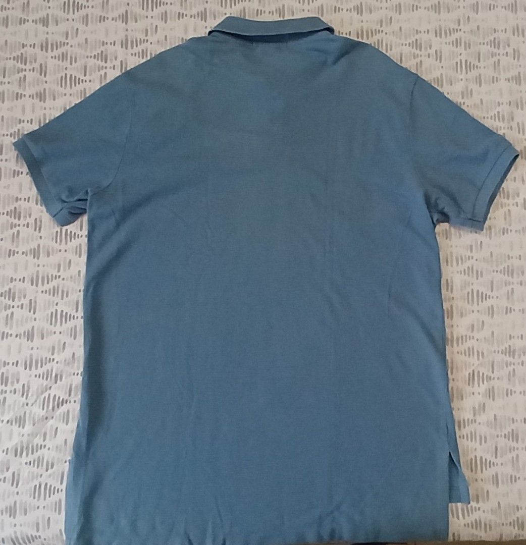 Ralph Lauren Polo Shirt (Category: Activewear) located in Antipolo. Submitted by d.tuazon (Listing ID 1443723304, Image 2). Description: This is a blue Polo Ralph Lauren polo shirt featuring an embroidered yellow pony logo.Custom Slim Fit Mesh Polo Shirt: Around ₱8,950 if brandnew in Rustans Dept.Store.Size 22 inches width and 29 inches length.Price 375 only.Rizal area.Shipping sagot ng buyer..