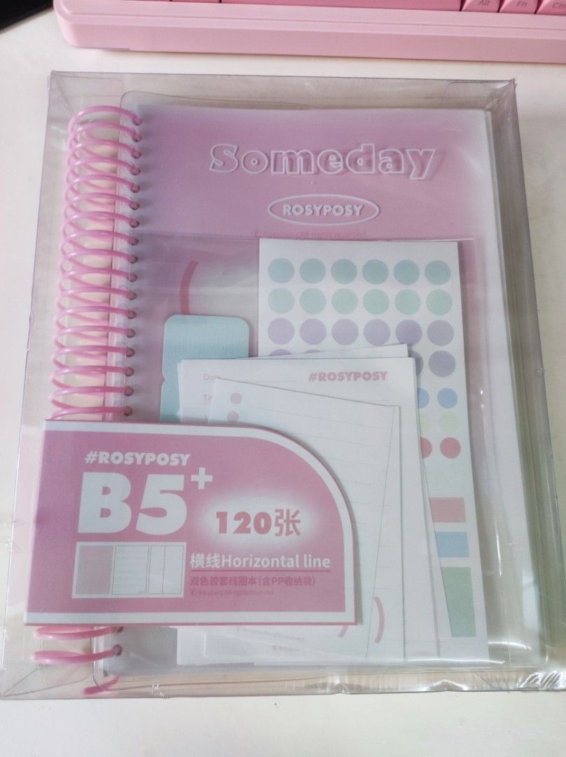 Rosyposy B5 Horizontal Line Notebook Set with Stickers (Category: Stationery & School Supplies) located in Taguig. Submitted by rukachi (Listing ID 1443803186, Image 1). Description: - Rosyposy B5 Notebook Set - 120 sheets of horizontal lined pages - Includes cute round stickers and other stationery bits - Available in blue (3pcs) or pink (1pc left) - Ideal for daily planning and journaling ✨ Promo: Get ₱50 off for every 2 sets purchased! Buy 2 s