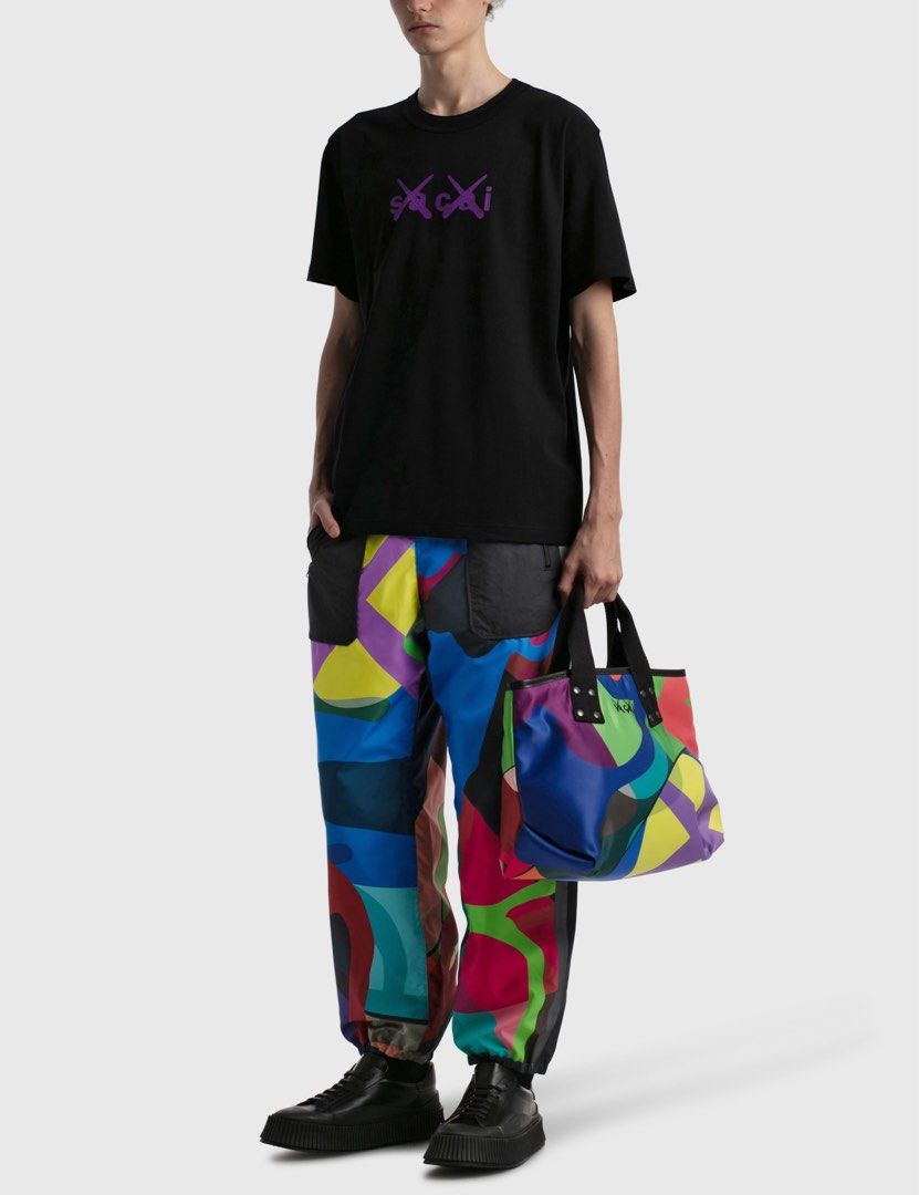 sacai x KAWS - Flock Print Shirt (Category: Tshirts & Polo Shirts ) located in Los Banos. Submitted by declutterking (Listing ID 1443864754, Image 2). Description: Size 1 on tag • Sacai x KAWS collaboration • Short sleeve • Relaxed fit • Ribbed crewneck • Signature KAWS crossed-out eyes and Sacai logo prints on chest • Sacai logo print below back neckline Dimensions: 18" shoulders 20.25" chest 27.75" length 8.75" sleeves Good as new condition Aut