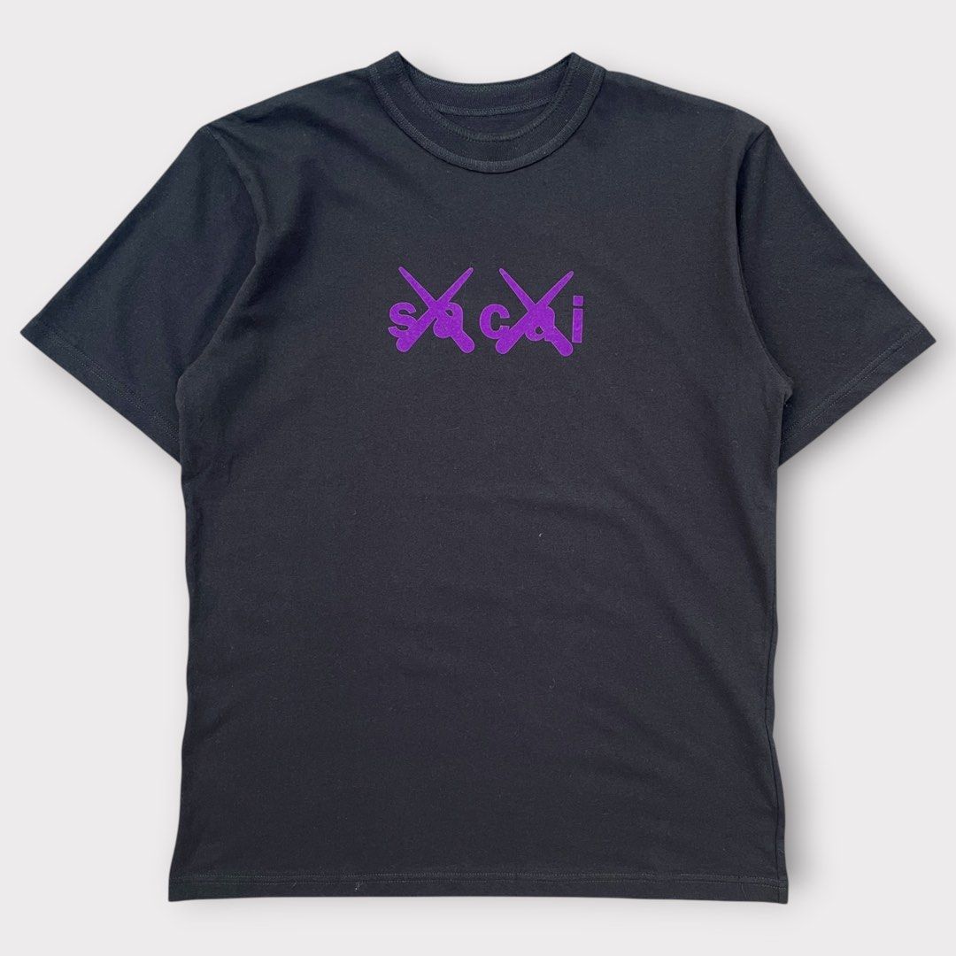 sacai x KAWS - Flock Print Shirt (Category: Tshirts & Polo Shirts ) located in Los Banos. Submitted by declutterking (Listing ID 1443864754, Image 3). Description: Size 1 on tag • Sacai x KAWS collaboration • Short sleeve • Relaxed fit • Ribbed crewneck • Signature KAWS crossed-out eyes and Sacai logo prints on chest • Sacai logo print below back neckline Dimensions: 18" shoulders 20.25" chest 27.75" length 8.75" sleeves Good as new condition Aut