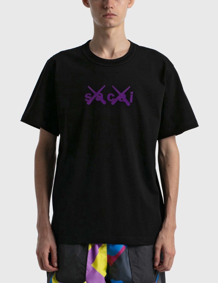 sacai x KAWS - Flock Print Shirt (Category: Tshirts & Polo Shirts ) located in Los Banos. Submitted by declutterking (Listing ID 1443864754, Image 1). Description: Size 1 on tag • Sacai x KAWS collaboration • Short sleeve • Relaxed fit • Ribbed crewneck • Signature KAWS crossed-out eyes and Sacai logo prints on chest • Sacai logo print below back neckline Dimensions: 18" shoulders 20.25" chest 27.75" length 8.75" sleeves Good as new condition Aut