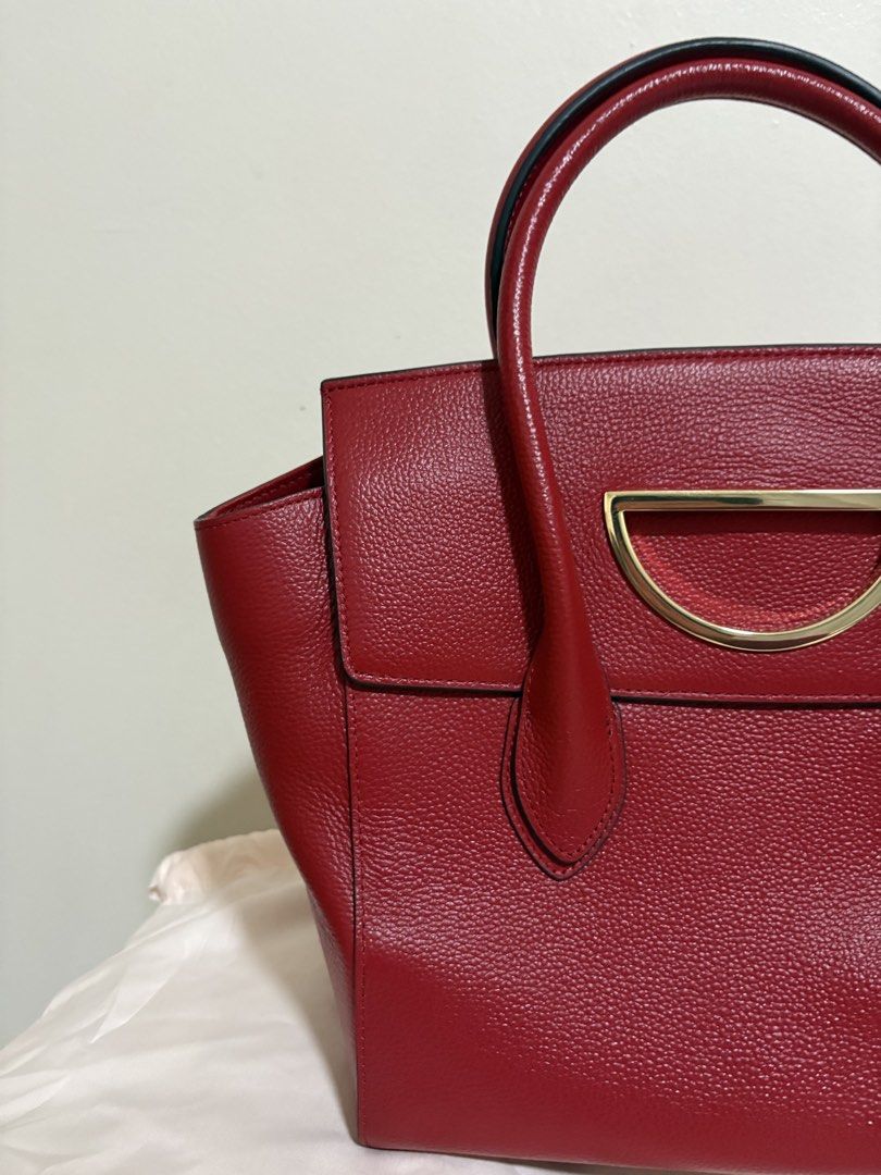 Samantha Thavasa Red Leather Top Handle Bag (Category: Luxury Bags & Wallets) located in Del Monte. Submitted by gentlehawk-37b0 (Listing ID 1443751340, Image 2). Description: - Authentic Samantha Thavasa red leather handbag - Textured leather finish - Elegant gold hardware detail on the front - Comfortable top handles for carrying - Spacious interior for all your essentials - Comes with original dust bag - Versatile: perfect for daily use or spe