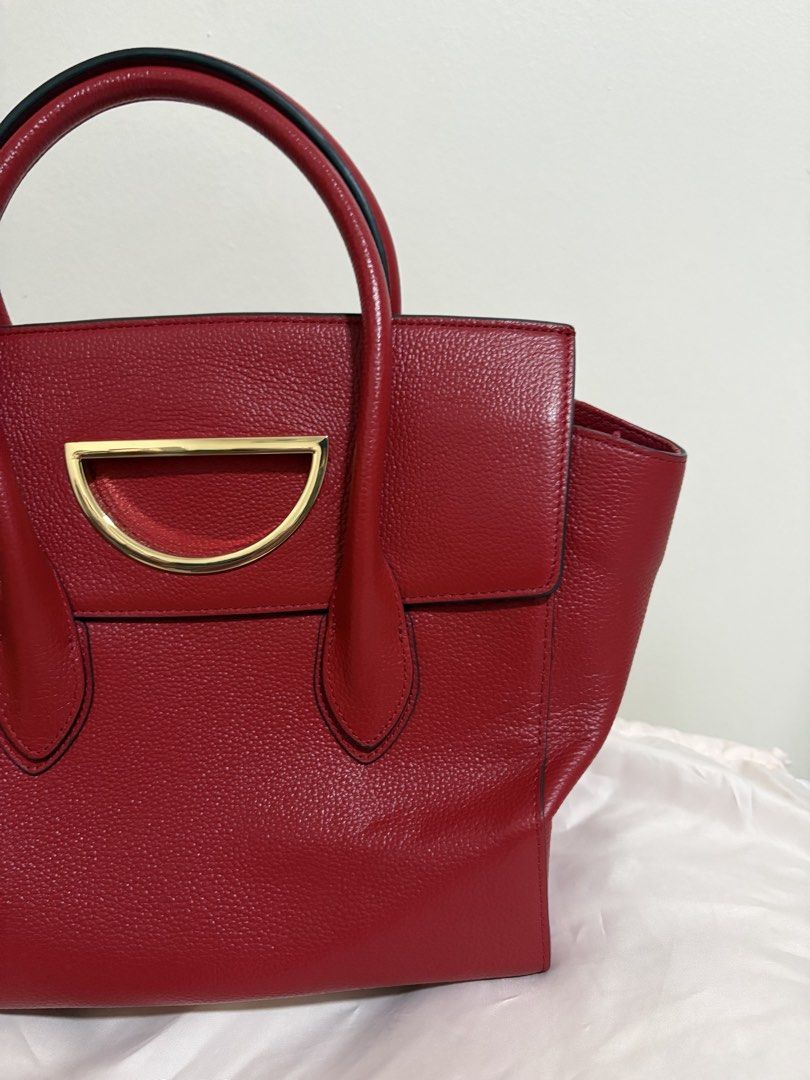 Samantha Thavasa Red Leather Top Handle Bag (Category: Luxury Bags & Wallets) located in Del Monte. Submitted by gentlehawk-37b0 (Listing ID 1443751340, Image 3). Description: - Authentic Samantha Thavasa red leather handbag - Textured leather finish - Elegant gold hardware detail on the front - Comfortable top handles for carrying - Spacious interior for all your essentials - Comes with original dust bag - Versatile: perfect for daily use or spe