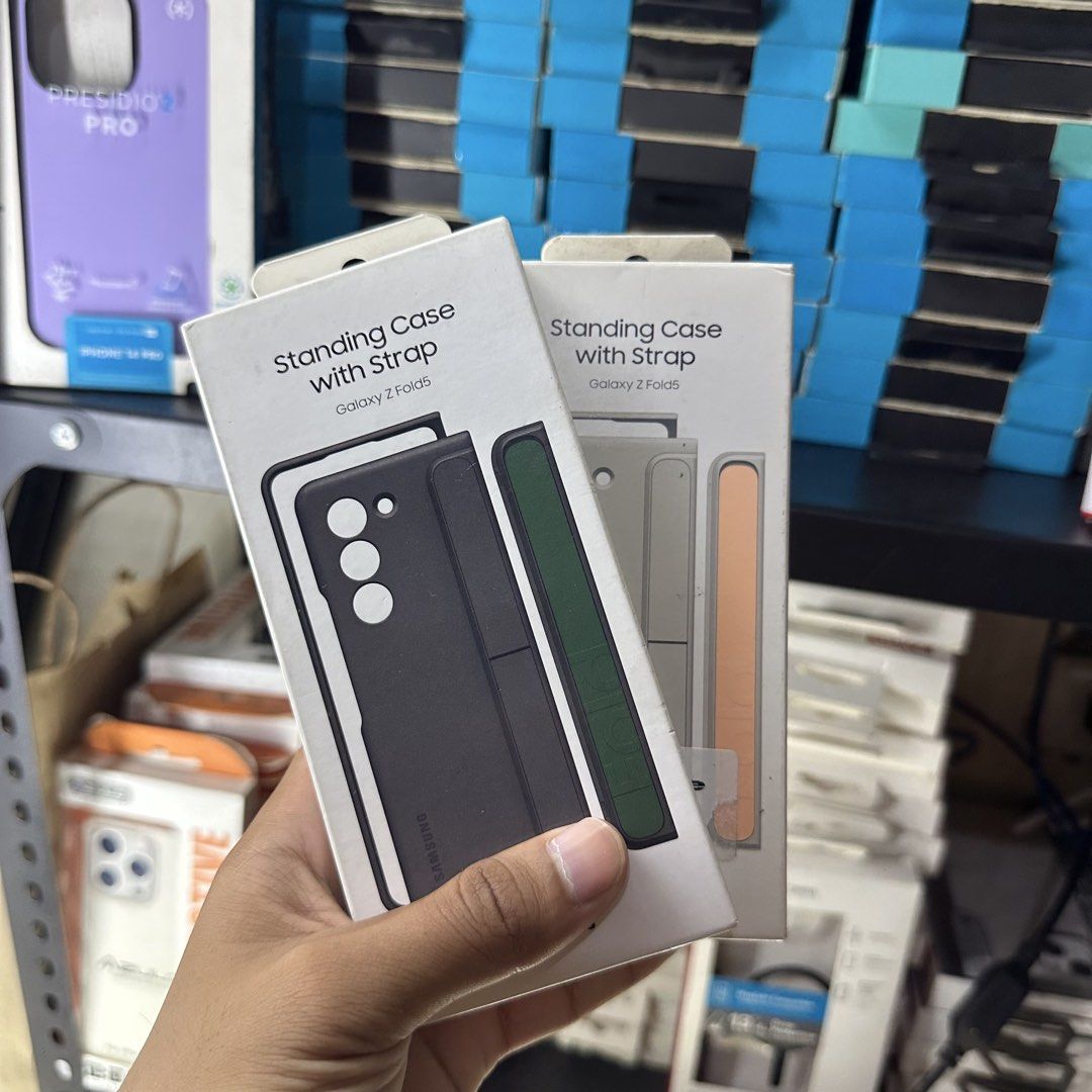 Samsung Fold 5 Case (Category: Cases & Sleeves) located in Manila. Submitted by ryan_cos (Listing ID 1443736488, Image 1). Description: - Official Samsung Standing Case with Strap - Designed for Samsung Galaxy Z Fold 5 - Features a built-in strap for secure grip - Doubles as a kickstand for hands-free viewing - Available in black and light gray color options - Offers protection and style for your Fold 5.