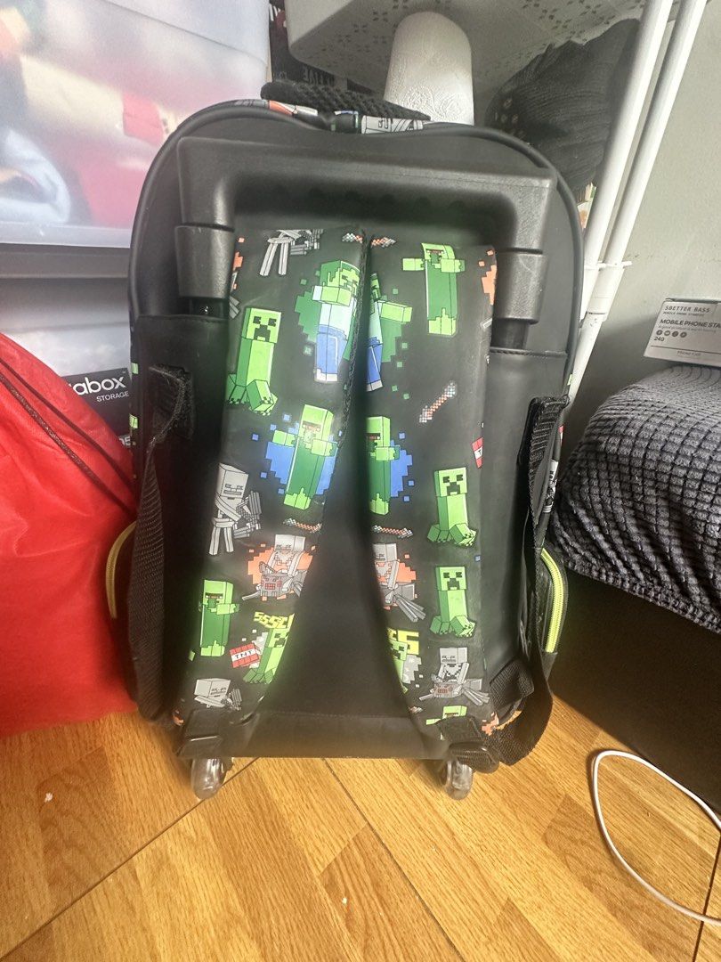 Smiggle Minecraft Trolley School Bag (Category: Babies & Kids Fashion) located in Cavite. Submitted by meng_207 (Listing ID 1443841162, Image 3). Description: - Official Smiggle trolley school bag - Features iconic Minecraft Creeper design - Plenty of storage space for books and supplies - Equipped with wheels and a retractable handle for easy mobility - Ideal for school, day trips, or travel adventures Good Condition my son does not use it anymo