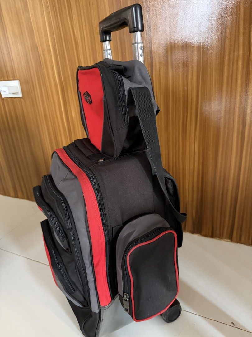 Sparky Trolley Bag (Category: Strollers) located in Caloocan City. Submitted by j.affordafindsph (Listing ID 1443668726, Image 2). Description: Authentic Puffy and Sparky Large Upright Stroller. Red and grey colorway. Has a retractable handle and wheels for easy transport. Multiple compartments and pockets for organization. Great for school or travel. Durable material. Detachable zippered side pocket on the other side Identification label at the 