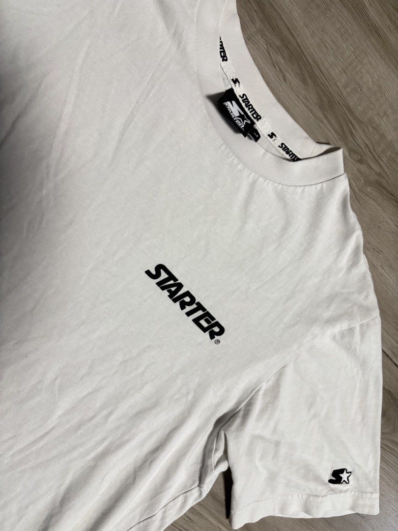 Starter White T-Shirt with Logo (Category: Tshirts & Polo Shirts ) located in Cavite. Submitted by cesxyyylll (Listing ID 1443823437, Image 2). Description: - Classic white Starter t-shirt - Features printed Starter logo on the chest - Smaller Starter logo detail on the sleeve - Comfortable and casual design - Ideal for everyday wear - Easily pairs with jeans or shorts.