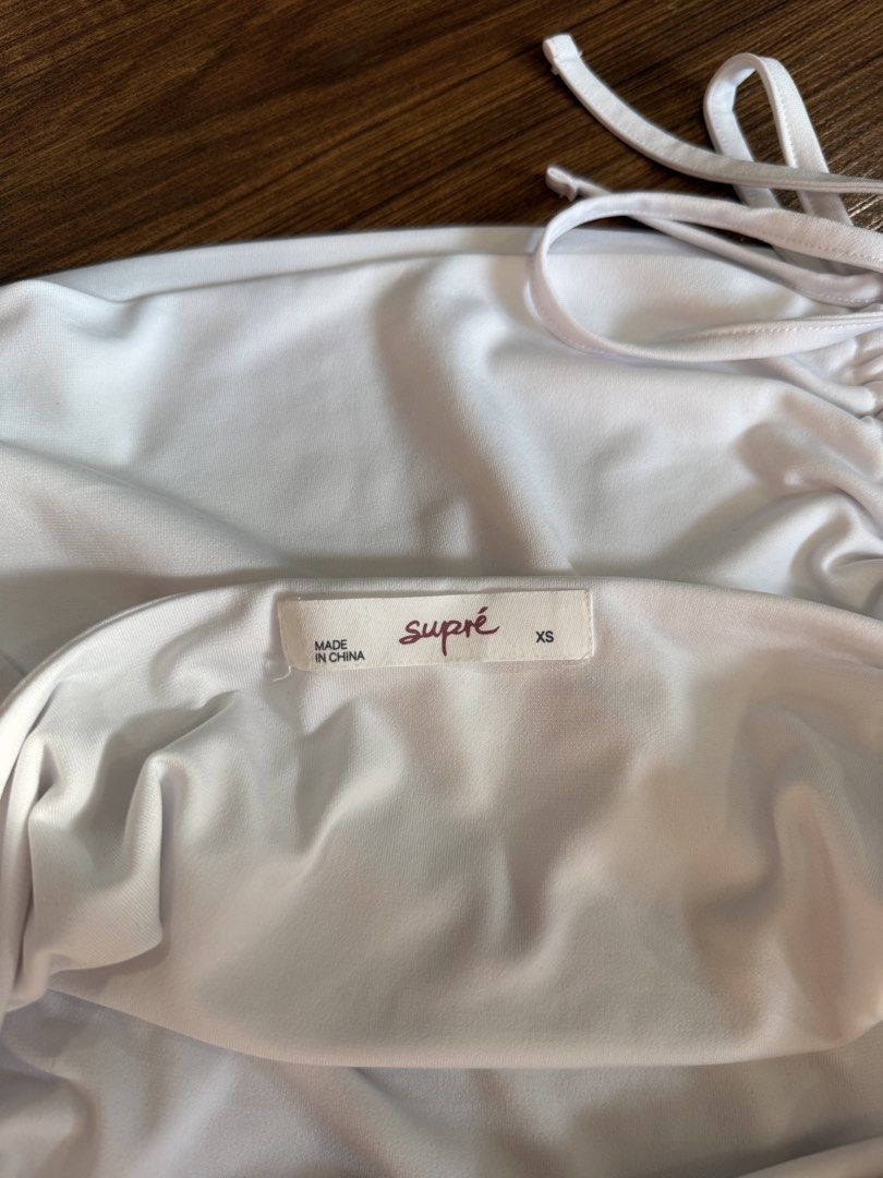 Supre White Ruched Halter Top XS (Category: Sleeveless) located in Quezon City. Submitted by closetcute (Listing ID 1443815999, Image 3). Description: Ruched sides with adjustable drawstring ties Ties at the neck for a customizable fit .