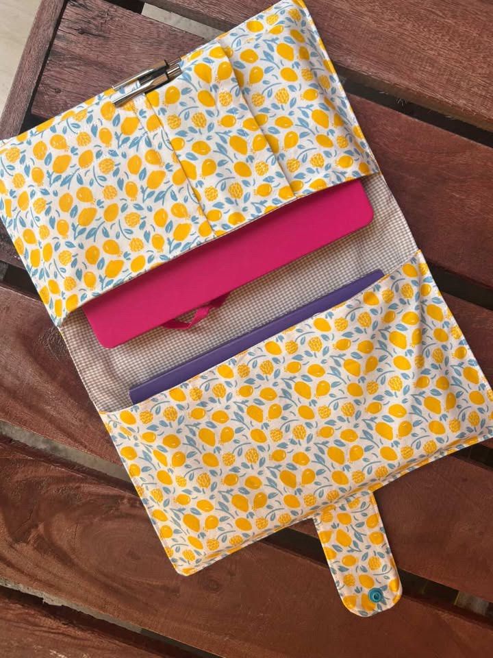 Tablet/Journal Sleeve (Category: Cases & Sleeves) located in General Trias. Submitted by erikajjj (Listing ID 1443702440, Image 1). Description: - Handmade tablet sleeve with a fun lemon print. - Multiple interior pockets for tablet, pens, and essentials. - Secure flap closure to keep items safe. - Ideal for organizing your tech while traveling. - Approximate dimensions: 13 inches x 10 inches (when open)..