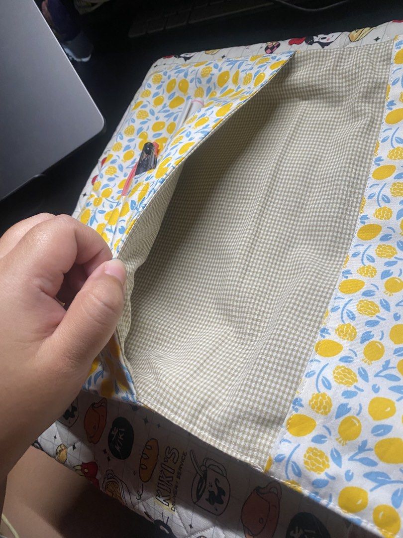 Tablet/Journal Sleeve (Category: Cases & Sleeves) located in General Trias. Submitted by erikajjj (Listing ID 1443702440, Image 2). Description: - Handmade tablet sleeve with a fun lemon print. - Multiple interior pockets for tablet, pens, and essentials. - Secure flap closure to keep items safe. - Ideal for organizing your tech while traveling. - Approximate dimensions: 13 inches x 10 inches (when open)..