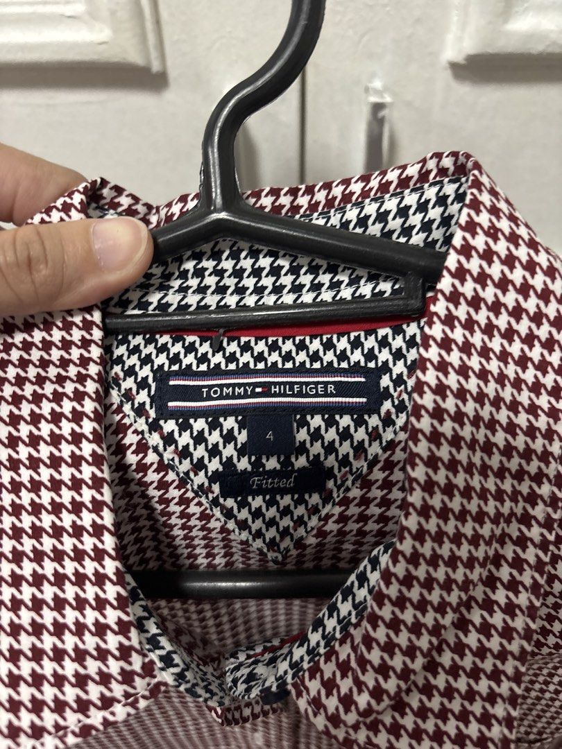 Tommy Hilfiger Men's Long Sleeve Button Down Shirt (Category: Tshirts & Polo Shirts ) located in Imus. Submitted by karoleiza (Listing ID 1443801336, Image 2). Description: - Classic Tommy Hilfiger button-down shirt - Eye-catching red and white houndstooth pattern - Long sleeves with button cuffs - Convenient single chest pocket on the left - Stylish contrasting patterned collar lining - Perfect for smart casual outfits.