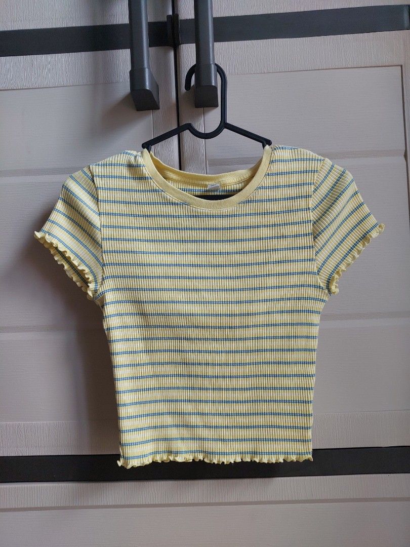 UNIQLO Striped Ribbed Top Size S (Category: Shirts) located in Pasay City. Submitted by mcleo10 (Listing ID 1443769823, Image 1). Description: - Yellow ribbed top - Features blue stripes - Lettuce hem detail on sleeves and bottom - Estimated size: Small (S) - Ideal for casual wear.