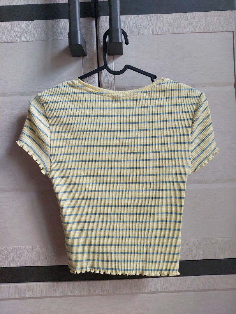 UNIQLO Striped Ribbed Top Size S (Category: Shirts) located in Pasay City. Submitted by mcleo10 (Listing ID 1443769823, Image 2). Description: - Yellow ribbed top - Features blue stripes - Lettuce hem detail on sleeves and bottom - Estimated size: Small (S) - Ideal for casual wear.
